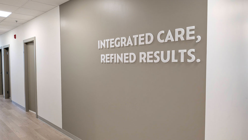 Clinic hallway with Integrated Care, Refined Results lettering on the wall